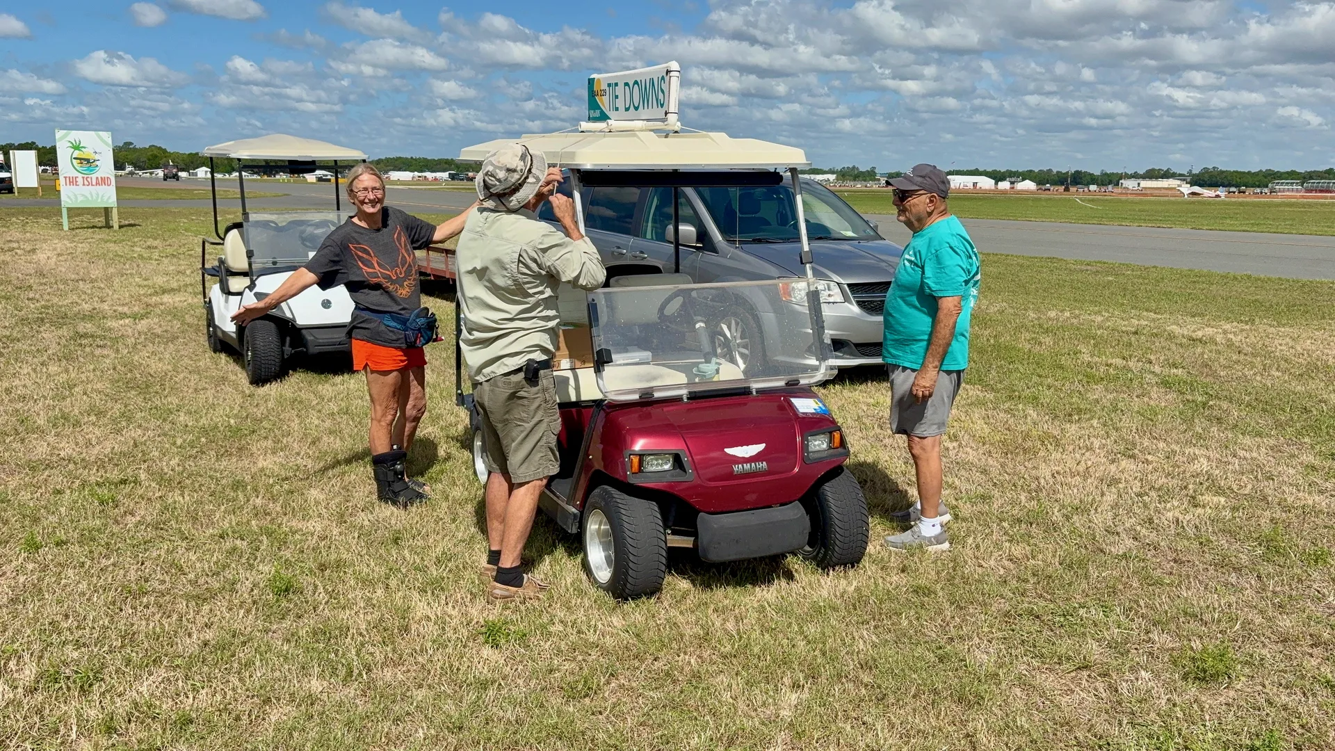 EAA Chapter 229 volunteers setting up the Tie Downs sign on the golf cart at Sun n Fun 2026