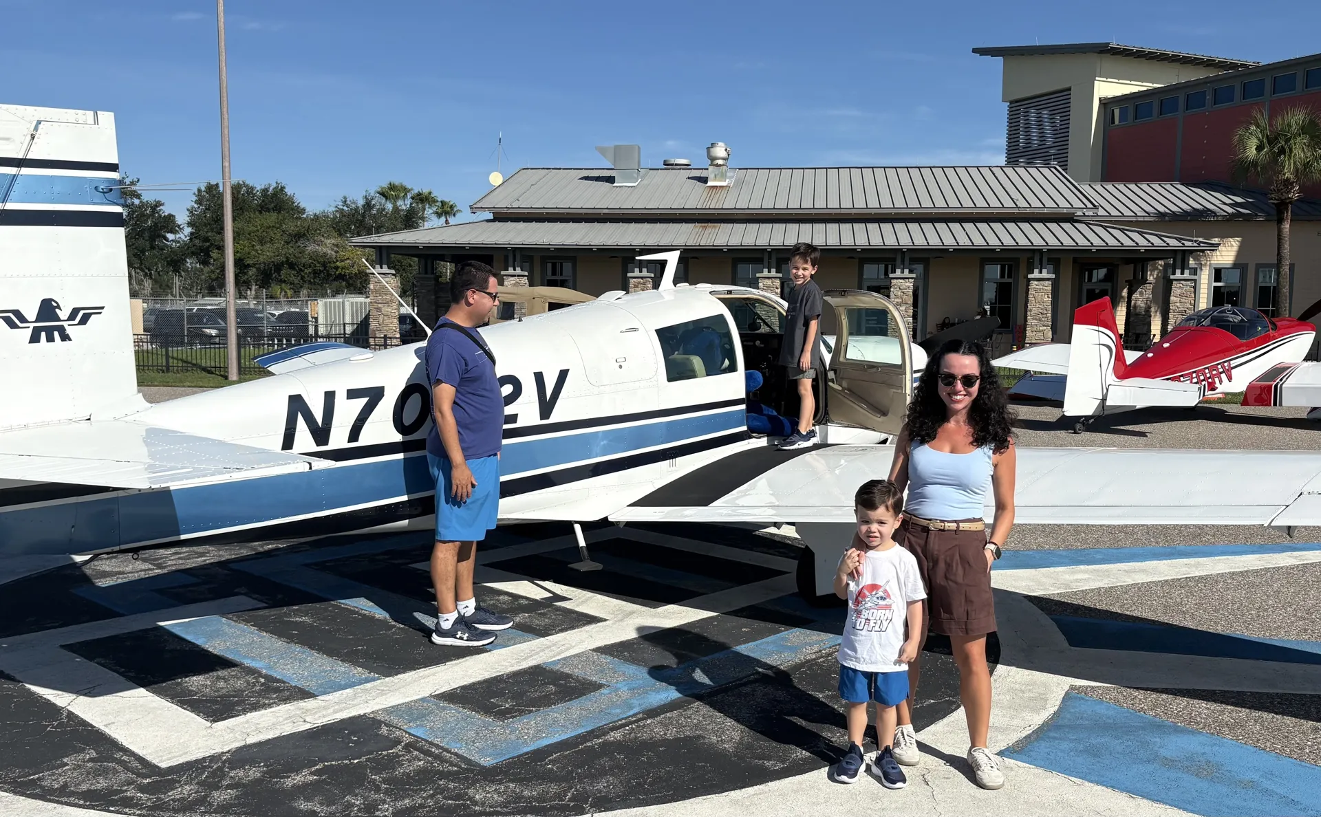 A family poses with N7022V, door open, ready to climb aboard